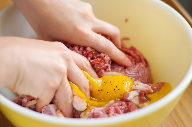 mixing bacon burgers