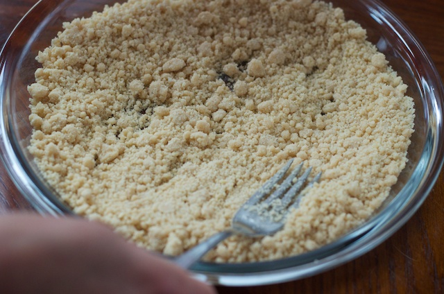 pressing crust into pie pan