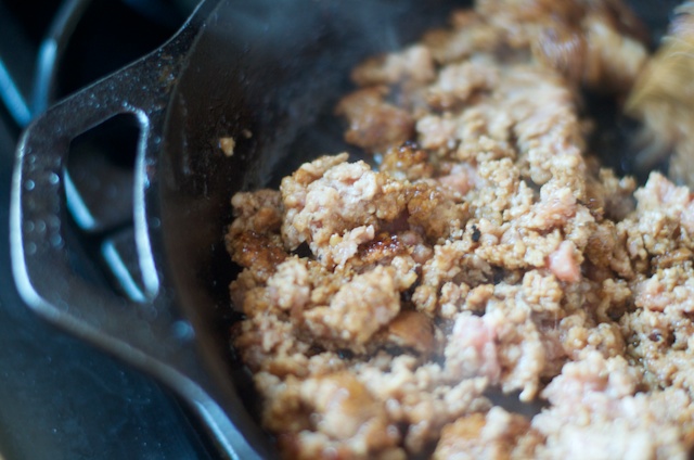 pork sausage in skillet browning